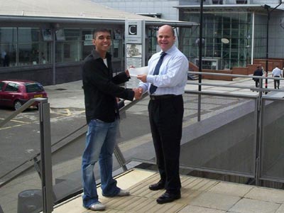 Hardip Singh receives cheque from David Hodgson, PR department, Caledonian University to assist with funding for USA world championships.